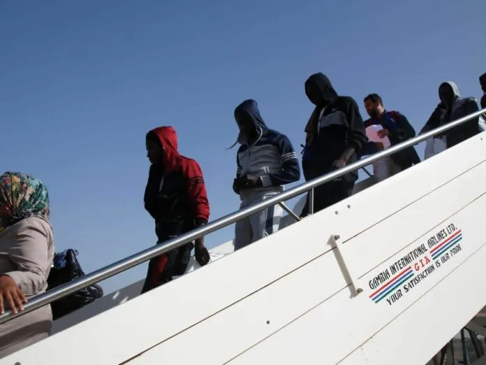 Migrants returning home to The Gambia boarding a Gambia International Airlines flight