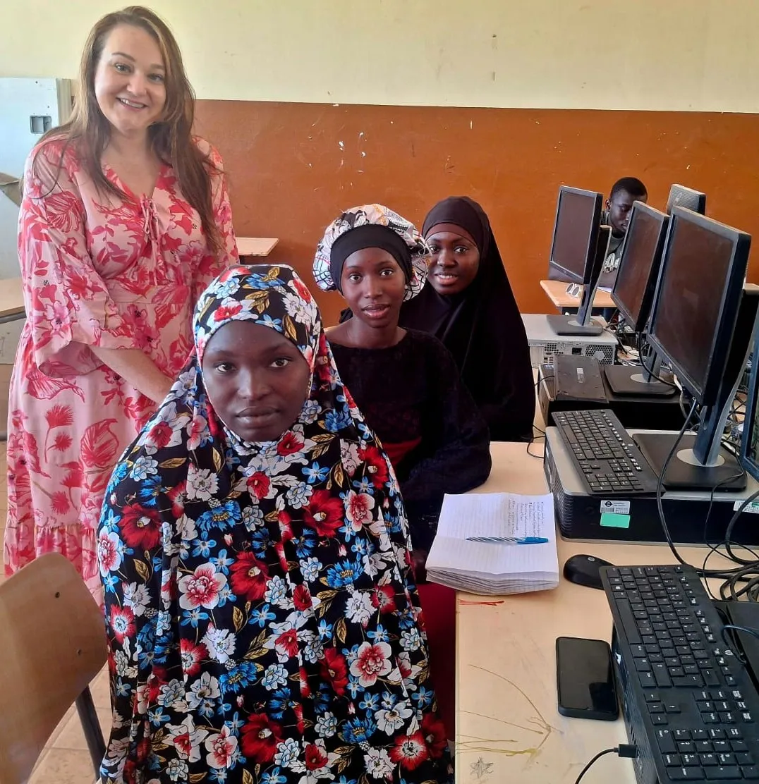 Girls In Tech mentor with students at computers